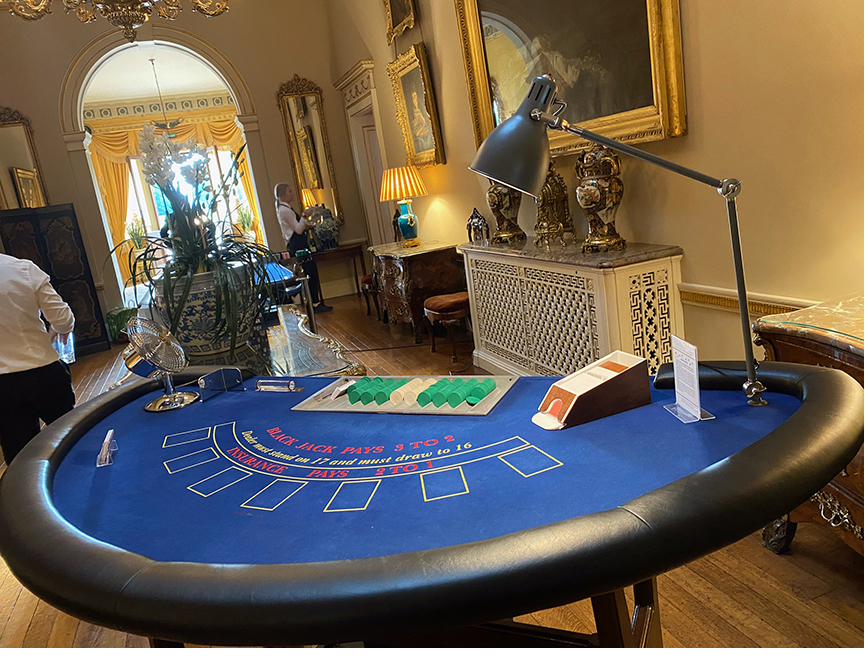 Guests laughing together around a casino table
